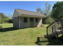 Exterior view of block outbuilding with secure door; great for storage and projects at 125 S State St, Haw River, NC 27258