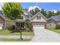 Well-maintained two-story home with a brick and stone facade, lush lawn, and attached two-car garage at 126 Elmsford St, Durham, NC 27703