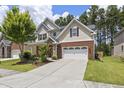 Attractive two-story home featuring a manicured lawn and an attached two-car garage at 126 Elmsford St, Durham, NC 27703