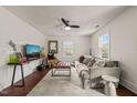 Bright living room featuring a sofa, stylish rug, modern furniture, and a ceiling fan at 12601 Boyce Mill Rd, Raleigh, NC 27613