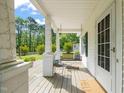 Inviting front porch offers a relaxing space with swing and view of the landscaped yard at 12601 Boyce Mill Rd, Raleigh, NC 27613