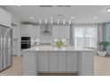 Modern kitchen features a large island, stainless steel appliances, and stylish pendant lighting at 1265 Meadow Queen Ln, Apex, NC 27502