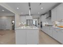 Open-concept kitchen with a spacious island, stainless steel appliances and hardwood floors at 1265 Meadow Queen Ln, Apex, NC 27502