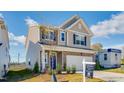 Beautiful two-story home featuring stone accents, a two-car garage, and blue front door at 130 N Finley Landing Pkwy, Smithfield, NC 27577