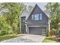 Stylish two-story home featuring modern gray and white exterior finishes, a paved driveway, and a well-maintained lawn at 1336 Courtland Dr, Raleigh, NC 27604