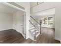 Bright entryway featuring hardwood floors, elegant staircase, and glass-paneled office doors at 134 Ivy Ridge Rd, Chapel Hill, NC 27516