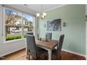 Cozy dining area featuring a rustic wood table, stylish seating, and a large window at 15 Plumas Drive Dr, Durham, NC 27705