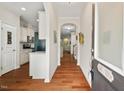 Inviting entryway with hardwood floors and arched doorways leading to the kitchen and living spaces at 15 Plumas Drive Dr, Durham, NC 27705