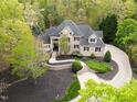 Expansive aerial view of a brick home featuring lush landscaping and a winding driveway at 16106 Morehead, Chapel Hill, NC 27517