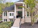 Elegant brick home featuring a columned front entrance with seasonal wreaths and manicured landscaping at 16106 Morehead, Chapel Hill, NC 27517