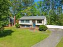 Two-story home with a manicured lawn and a long driveway leading to a detached garage at 1624 Cone Ave, Apex, NC 27502