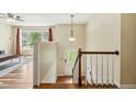 Bright entryway with hardwood floors, staircase, and view into the living room at 1624 Cone Ave, Apex, NC 27502
