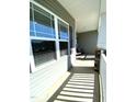 View of the porch from the side; seating and natural light at 173 Silver Tee Ct, Selma, NC 27576