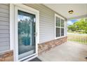 Covered front porch with stone accents and a glass front door at 2 White Spruce Ct, Durham, NC 27703