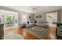 Spacious living room with hardwood floors, a sectional sofa, and a dining area view at 2004 Valley Ridge Ct, Raleigh, NC 27603
