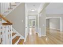 Bright foyer featuring hardwood floors and elegant staircase at 207 Ashley Brook Ct, Cary, NC 27513