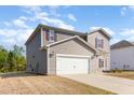 Two-story home features neutral siding, white garage door, red shutters and well maintained lawn at 217 Braeburn Dr, Graham, NC 27253