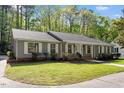 Inviting single-story home with a lush lawn, well-manicured landscaping, and charming exterior at 2225 Whitley Dr, Durham, NC 27707