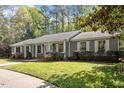 Beautiful single-story home with a well-kept lawn, mature trees, and welcoming curb appeal at 2225 Whitley Dr, Durham, NC 27707