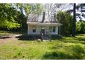 Exterior of home with a small porch, roof and yard with trees at 223 Gum Ave, Spring Hope, NC 27882