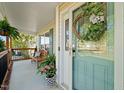Inviting covered porch with a wreath on the front door and a wooden bench at 226 Marquis Dr, Cameron, NC 28326