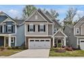 Charming two-story home features a stone facade and an attached two-car garage at 2283 Grants Pass Sta, Apex, NC 27502