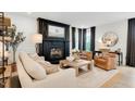Bright living room featuring a fireplace, large picture window, modern decor, and comfortable seating at 2283 Grants Pass Sta, Apex, NC 27502