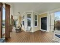 Inviting front porch with wooden floors, rocking chairs, and a cozy seating area at 233 Pointe Park Cir, Holly Springs, NC 27540