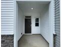Welcoming covered entryway with a dark wood door and a sidelight window for natural illumination at 236 Paramount Dr, Smithfield, NC 27577