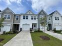 Attractive townhome showcasing a well-manicured lawn and inviting curb appeal in a desirable neighborhood at 236 Paramount Dr, Smithfield, NC 27577