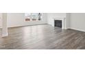 A well-lit living room with wood floors and a fireplace at 2613 Red Spruce Dr, Raleigh, NC 27616