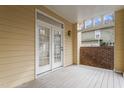 Covered back patio featuring white trim, double doors and serene outdoor views at 269 Sweet Bay Pl, Carrboro, NC 27510