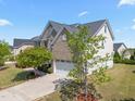 A lovely two-story home shows its brick exterior and a driveway leading to a two-car garage at 316 Hilliard Forest Dr, Cary, NC 27519