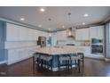 Modern kitchen with large island, granite countertops, stainless steel appliances, and ample cabinet space at 3205 Silver Ore Ct, Wake Forest, NC 27587