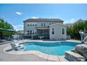 Gorgeous backyard pool with waterfall feature, lounge area, and well-maintained landscaping at 3205 Silver Ore Ct, Wake Forest, NC 27587