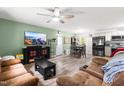 Open-concept living and dining area with a large TV, comfortable seating, and lots of natural light at 329 Cartwright Cir, Wendell, NC 27591