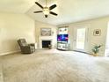 Cozy living room with vaulted ceilings, a fireplace, and comfortable seating area at 334 Cabin Grove Ct, Angier, NC 27501