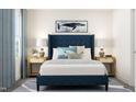 Stylishly furnished bedroom with a blue upholstered bed and elegant décor at 336 Carolina Springs Blvd, Apex, NC 27539