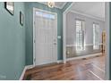 Bright foyer featuring hardwood floors, neutral paint, and transom window, creating an inviting entry at 3809 Long Meadow Dr, Mebane, NC 27302