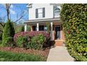 Inviting front porch with brick accents and colorful landscaping leading to a welcoming entrance at 3809 Long Meadow Dr, Mebane, NC 27302