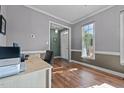 Home office with ample natural light, neutral walls, and hardwood flooring for a productive workspace at 3809 Long Meadow Dr, Mebane, NC 27302