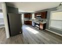 Updated kitchen with stainless steel appliances, dark wood cabinets and new floors at 3815 Weyburn Rd, Durham, NC 27704