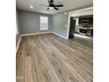 Inviting living room featuring new floors, neutral paint, and a ceiling fan at 3815 Weyburn Rd, Durham, NC 27704