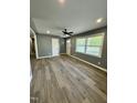 Bright living room with new floors, fresh paint, and a large window for natural light at 3815 Weyburn Rd, Durham, NC 27704