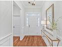 Bright foyer featuring hardwood floors, a decorative mirror, and a chandelier at 4 Calwell Creek Dr, Chapel Hill, NC 27517