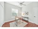 Bright, spacious office with hardwood floors, a ceiling fan, and natural light from a window at 4 Calwell Creek Dr, Chapel Hill, NC 27517