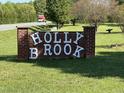 Holly Brook community entrance sign with brick surround and white lettering at 4047 Mistletoe Dr, Burlington, NC 27217