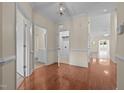 Bright entryway with hardwood floors and views of the bathroom, laundry room, and living spaces at 4105 Gilchrist Dr, Burlington, NC 27215