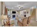 Spacious living room boasts a fireplace, staircase, and seamless flow to the adjacent kitchen at 412 Airedale Trl, Garner, NC 27529