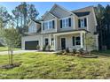 Charming two-story home with a two-car garage, a covered porch, and landscaped yard at 437 Earnest Way, Kenly, NC 27542
